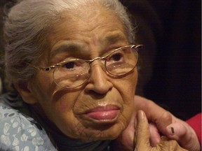 In this Saturday, Dec. 1, 2001 file photo, civil rights pioneer Rosa Parks holds the hand of a well-wisher at a ceremony honouring the 46th anniversary of her arrest for civil disobedience.