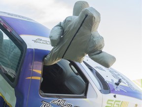 A dummy flies through the window of SGI's Rollover Simulator during a press conference to mark the 40th year of the province's seatbelt law.