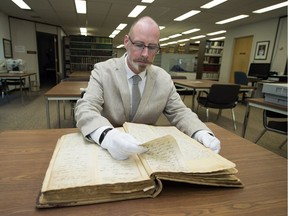 Curt Campbell, manager of the Preservation Management & Digital Records Program at the Provincial Archives of Saskatchewan, looks through the ledger filled with telegrams sent between General Frederick Middleton's forces in Saskatchewan and Prime Minister Sir John A. Macdonald's government in Ottawa during the time of the North-West Resistance.