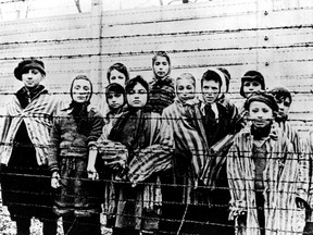 A photo taken just after the liberation by the Soviet army shows a group of children wearing concentration camp uniforms at the Auschwitz Nazi concentration camp on January 27, 1945.