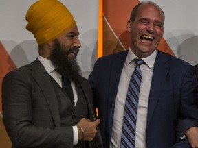 Jagmeet Singh and Guy Caron share a laugh after the federal NDP leadership debate at TCU Place in Saskatoon on July 11.