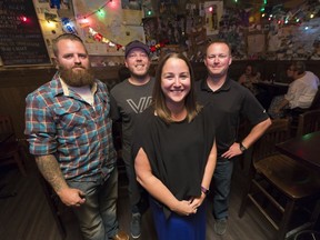 Mark Barnard, Andy Hilderman, Julie Slade and Mike Landry pose for a photo at Leopold's Tavern East. The friends met to mark the 10-year anniversary of Slade's rescue by the three Reginans.