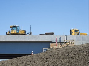 Crews work near a bridge, part of the Regina Bypass at Tower Road and the Trans-Canada Highway.