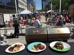 A view from the judges' table. Chefs Trevor Maghoo (from left), Terry Selinger and Chris Torjusen clean up their stations after plating their creations at the Regina Downtown/Regina Farmers' Market Canada Day Chefs' Challenge.