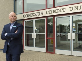 CEO of Conexus Credit Union Eric Dillon stands at a branch entrance at 1960 Albert St.