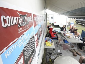 Country Thunder posters hang on the side of a trailer at Country Thunder music festival.