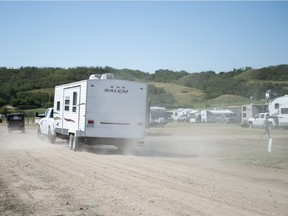 Dust flies as a truck and trailer makes its way down a gravel road near Craven.