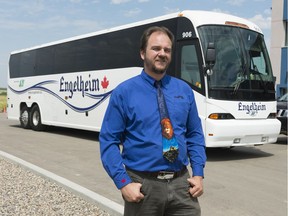 Shane Engel stands near an Engelheim Charter Inc. bus at the company's office near White City.