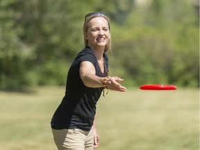Katya Herman, assistant professor in the Faculty of Kinesiology and Health Studies, throws a Frisbee on a soccer field. Herman is studying how seasons affect physical activity.