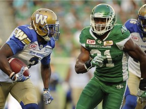 Roughriders special-team demon Glenn Love (31) lines up Winnipeg punt returner Kevin Fogg during a recent CFL game.