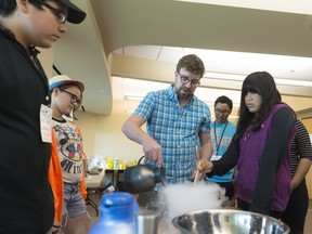 Professor Vincent Ziffle pours liquid nitrogen into a bowl during a session on the chemistry of ice cream at National First Nation and Inuit Youth Science Camp held at First Nations University of Canada.