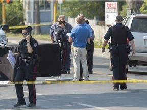 A person lays covered on the street as police investigate near 11th Ave. and Winnipeg St.