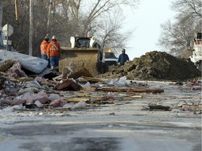 Workers clean up after a natural gas explosion at Regina Beach on Dec. 4, 2014. The area has been a concern because of slumping ground and in June 2017, SaskEnergy announced it would remove service from several homes.