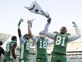 Saskatchewan Roughriders players Duron Carter, left, Josh Bartel, 18, and Bakari Grant, 81, had a lot to cheer about in Saturday's 38-27 win over the Toronto Argonauts.
