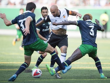 The New York Cosmos played the Valencia CF played as part of Soccer Day in Saskatchewan at Mosaic Stadium in Regina.  Valencia CF Simone Zaza tries to make his way through 3 Cosmos defenders.