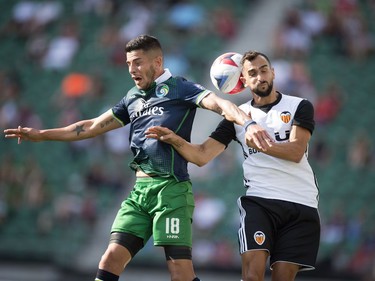 The New York Cosmos played the Valencia CF played as part of Soccer Day in Saskatchewan at Mosaic Stadium in Regina.  Cosmos' Emmanuel Ledesma, left, and Martin Montoya go up and fight for the ball.