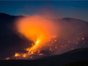 A wildfire burns on a mountain near Ashcroft, B.C., late Friday July 7, 2017. More than 3,000 residents have been evacuated from their homes in central British Columbia. A provincial state of emergency was declared after 56 new wildfires started Friday.