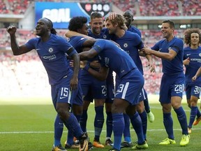 Chelsea&#039;s Victor Moses, left, celebrates with teammates after scoring his side&#039;s first goal during the English Community Shield soccer match between Arsenal and Chelsea at Wembley Stadium in London, Sunday, Aug. 6, 2017. (AP Photo/Frank Augstein)
