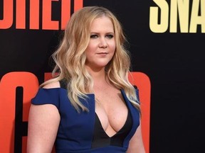 FILE - In this Wednesday, May 10, 2017, file photo, Amy Schumer arrives at the Los Angeles premiere of &ampquot;Snatched&ampquot; at the Regency Village Theatre. The actress and comedian will star in Steve Martin&#039;s four-person comedy ‚ÄúMeteor Shower‚Äù at the Booth Theatre starting in November. It‚Äôs about two couples who get together to observe the celestial event that inspires the title. (Photo by Jordan Strauss/Invision/AP, File)