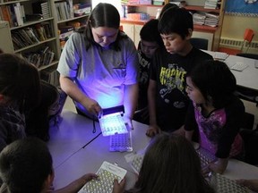 Inuit research associate Inez Shiwak, centre, shows students of Northern Lights Academy, in Rigolet, N.L., how the research team tested water for coliform bacteria and E. coli in an undated handout photo. Researchers studying higher rates of gastrointestinal illness in Inuit communities have a message for all Canadians: wash your water bottles and storage containers. THE CANADIAN PRESS/HO-Allan Gordon, *MANDATORY CREDIT*