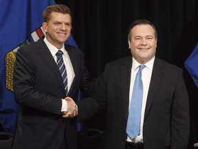 Alberta Wildrose leader Brian Jean and Alberta PC leader Jason Kenney shake hands after announcing a unity deal between the two in Edmonton on May 18, 2017.