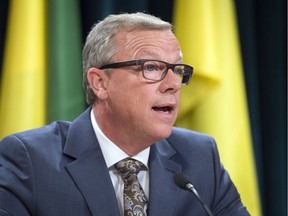 Premier of Saskatchewan Brad Wall, his wife Tami, and chief of operations and communications Kathy Young, back, enter a press conference where Wall announced he is retiring from politics at the Legislative Building in Regina, Sask., on Thursday, August 10, 2017. THE CANADIAN PRESS/Mark Taylor