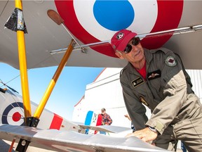 Pilot Allan Snowie, team leader of the Vimy Flight group, shows off a replica of the 1916 fighter plane Nieuport 11.