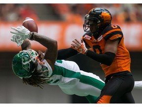 The Saskatchewan Roughriders' Naaman Roosevelt, left, was forced to battle for this underthrown pass — ultimately an incompletion — after quarterback Kevin Glenn was hit while releasing the ball Saturday against the B.C. Lions.