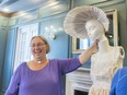 Caitlin Malone holds up a mannequin's head with a bonnet made of paper at the Hotel Saskatchewan. A group of Jane Austen devotees in Regin fashioned a paper dress of the author's letters. It's among a group of Austen-related fashions on display during the Jane Austen Festival which runs Sept. 6 to 23.