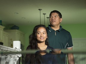 Venone Bihag, right, and his daughter Hannah at their home in Regina.