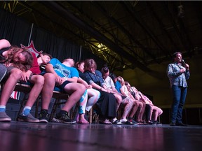 Hypnotist Wayne Lee keeps an audience entertained by putting a group of people to sleep during the Queen City Ex at Evraz Place in Regina, Saskatchewan on August 6, 2017.