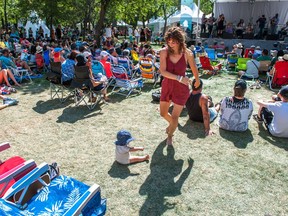 Kayleigh Rice dances to the music of a band playing on a stage at the Regina Folk Festival in Victoria Park on August 13, 2017.