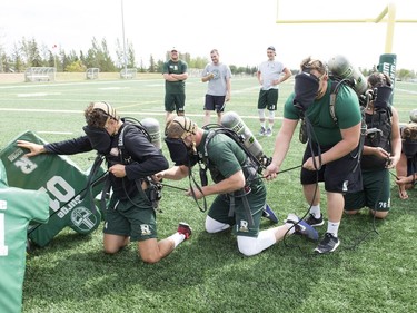 The Regina Fire & Protective Services teamed up with the University of Regina Rams for a team building exercise during Rams training camp held on their practice field.  A team of 5 football players took part in a recovery exercise where their visions were blacked out to simulate zero visibility smoke conditions inside a home on fire and were required to follow a line to recover a dummy body and return it to the goal post as a team of 5.