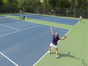 Sandy Harazny is shown serving at the Lakeshore Tennis Club.