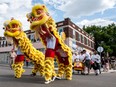 Chung Wah Kung Fu Regina group performs a traditional Chinese Lion Dance at an unveiling ceremony for an art installation honouring Yee Clun at the Art Park in the Heritage neighbourhood in Regina, Saskatchewan on August 7, 2017.