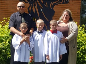 Sherra and Mike Zagrodney at their sons Timothan (left), Trevin (middle) and Trendon's (right) confirmation on June 18. Trendon passed away in July after a severe asthma attack caused by an allergic reaction.
