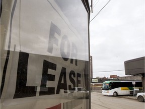 A sign advertising a building for lease as a Saskatchewan Transportation Company (STC) bus departs the depot in Saskatoon on March 28, 2017.