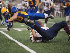 Hilltops running back Josh Ewanchyna is tackled by Regina Thunder defensive lineman Braxton Turnbull  on Saturday.