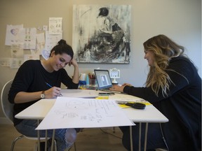 Kate Cowles and Kate Hofstra sit at their desk where they make LGBTQ+ cards in Saskatoon, SK on Thursday, September 28, 2017.