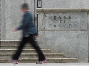 A woman walks past the Bank of Canada Wednesday September 6, 2017 in Ottawa. The Bank of Canada announced it would raise the benchmark interest rate by a quarter of a point to one per cent. THE CANADIAN PRESS/Adrian Wyld