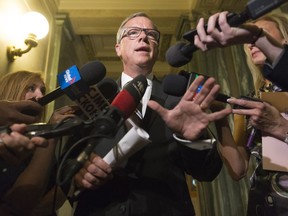 Premier Brad Wall speaks to reporters outside his office at the Legislative Building.