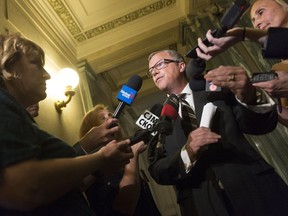 Premier Brad Wall speaks to reporters outside his office at the Legislative Building.