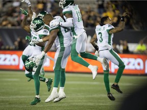 Members of the Saskatchewan Roughriders celebrate Friday's 27-19 victory over the host Hamilton Tiger-Cats.