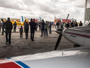 Visitors gather inside and outside the hanger to view unique aircraft during the Regina Flying Club's open house event in Regina, Saskatchewan on September 17, 2017.