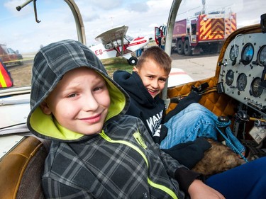 Aldan Henry (left) and Taevan Henry sit in the cockpit of a T-18 Thorp aircraft during the Regina Flying Club's open house event in Regina, Saskatchewan on September 17, 2017.