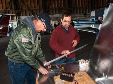 Ron Wood (left) and David Stanchuk help build a Zenith Aircraft kit plane for the Experimental Aircraft Association during the Regina Flying Club's open house event in Regina, Saskatchewan on September 17, 2017.