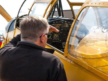 A visitor gazes into the cockpit of a PT-26 Cornell aircraft during the Regina Flying Club's open house event in Regina, Saskatchewan on September 17, 2017.