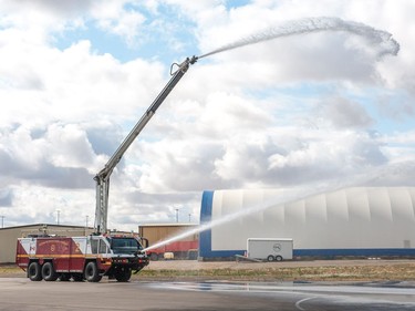 Firefighters demonstrate the capabilities of an Airport Rescue and Fire Fighting Rapid Intervention Vechicle during the Regina Flying Club's open house event in Regina, Saskatchewan on September 17, 2017.