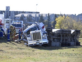 Emergency crews from multiple agencies work on transferring fuel from bulk fuel tanks on a Co-op fuel hauler that rolled onto its side into a second unit on site on the onramp to Albert Street North from the Ring Road in Regina.