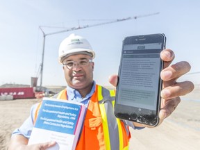 Collin Pullar, president of the Saskatchewan Construction Safety Association, shows off the organization's Occupational Health and Safety legislation app at the Sherwood Industrial Park Potable Water Treatment plant site. The app makes more than 500 pages of OHS regulations easier to understand and follow.